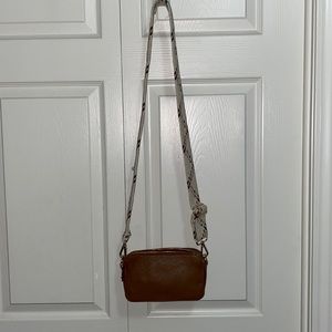Camera Crossbody w/ adj strap. Strap has minor manufacturing defect - see pic.